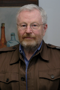 Photo of Prof. David Trubek, wearing a brown jacket over a blue collared shirt.