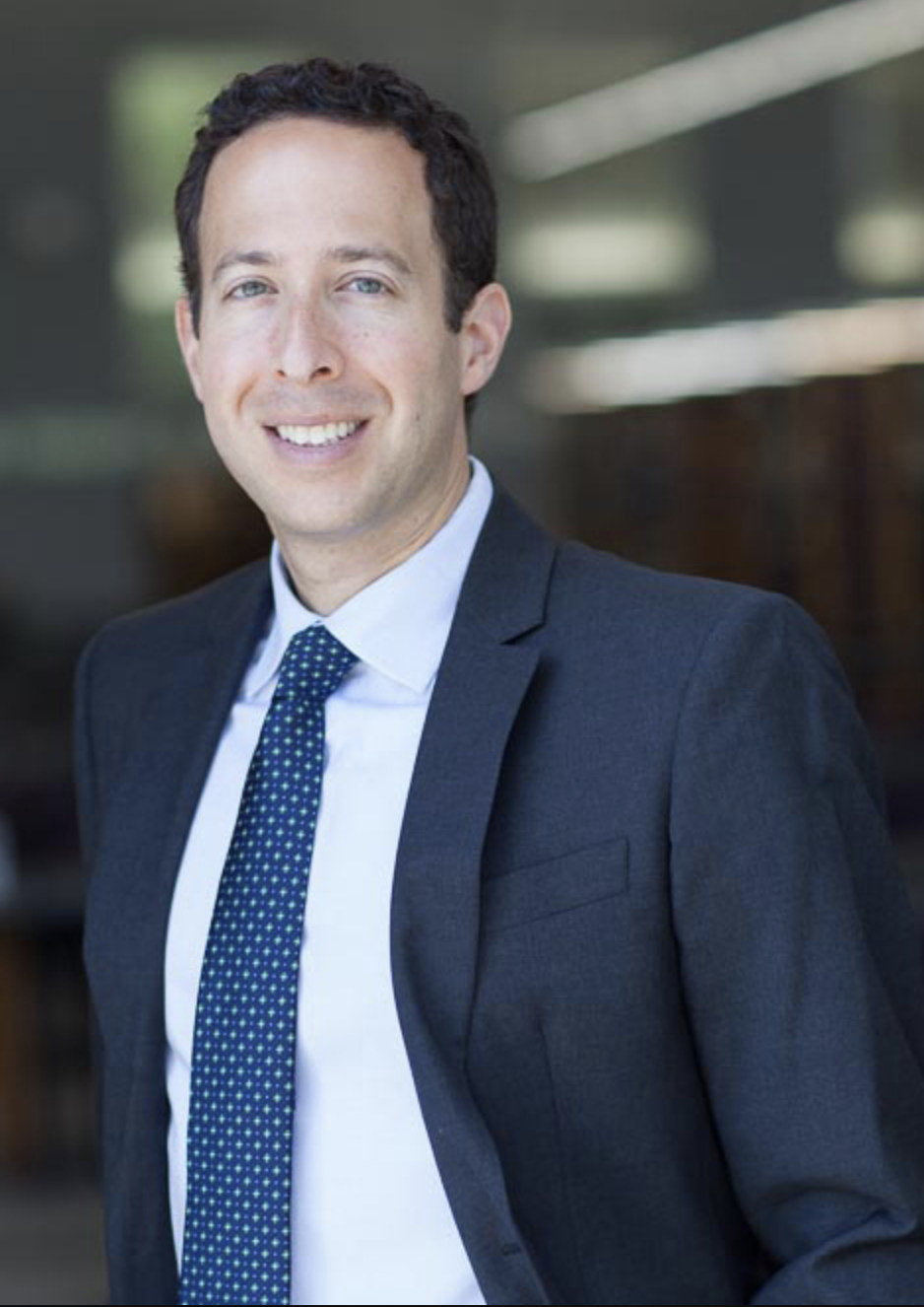Photo of Prof. Rob Yablon. He is wearing a suit with a blue tie.
